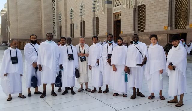 Amity Umrah group in ihram lined up outside a gate of Masjid an-Nabawi